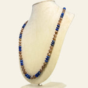 Necklace with blue and brown beads on a white mannequin bust