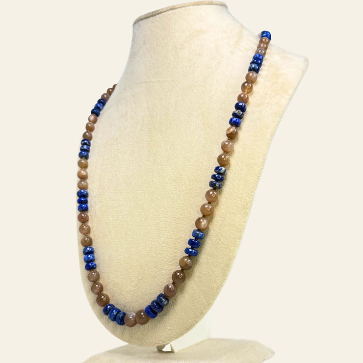Necklace with blue and brown beads on a white mannequin bust