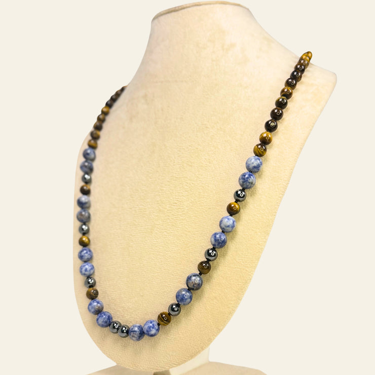 Necklace with blue and brown beads on a mannequin bust against a white background