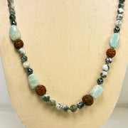 Necklace with multicolored beads on a mannequin bust against a white background