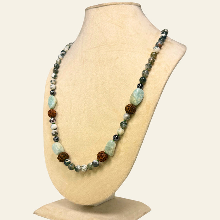 Necklace with multicolored beads on a mannequin bust against a white background