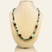 Necklace with multicolored beads on a mannequin bust against a white background