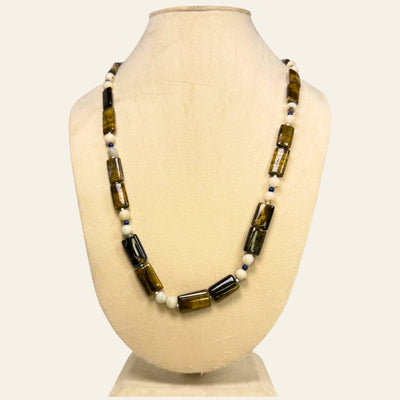Necklace with brown and white beads on a beige mannequin bust_ tiger eye beads_tribal and contemporary