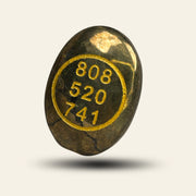 zibu stone with gold text '808 520 741' on a light_yellow_peace
